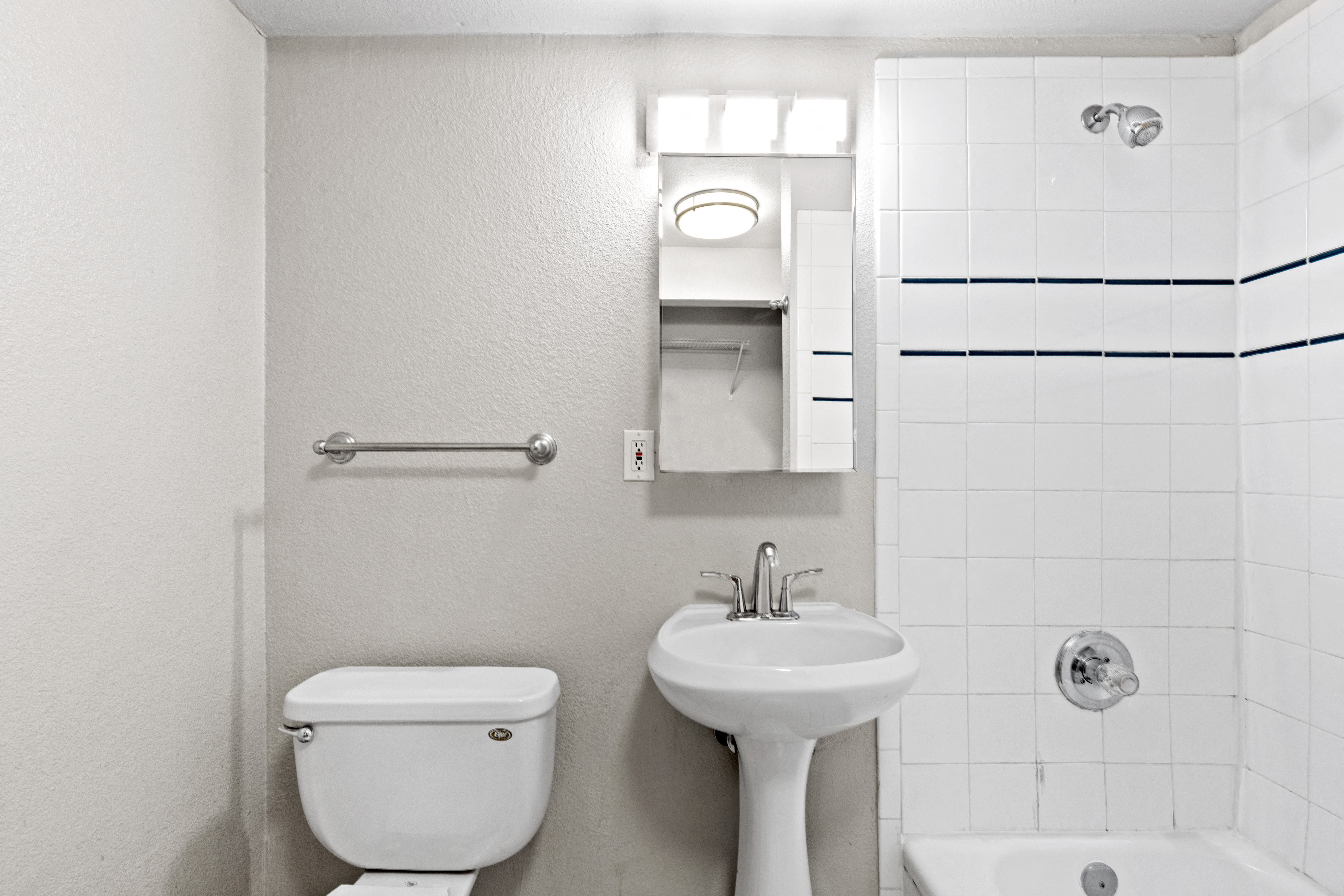 a bathroom with a sink toilet and a mirror